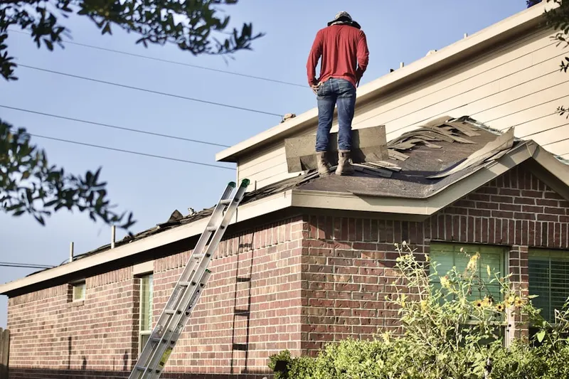 Professional roofer working on a residential roof in Farnhams